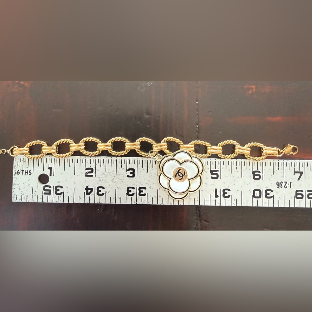 Chanel EUC Gold Tone bracelet
Camellia Enamel 3D charm on 7” 
Stainless Figaro - Picture 9 of 9